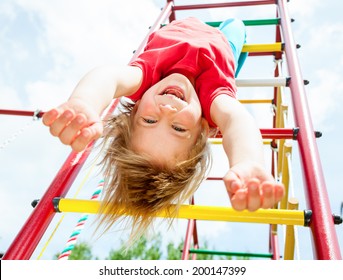 Little girl having fun playing on monkey bars - Powered by Shutterstock