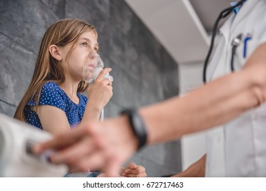 Little girl having a medical inhalation treatment with a nebulizer at the hospital - Powered by Shutterstock