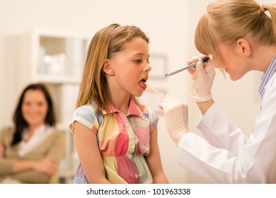 Little Girl Having Throat Examination With Tongue Depressor