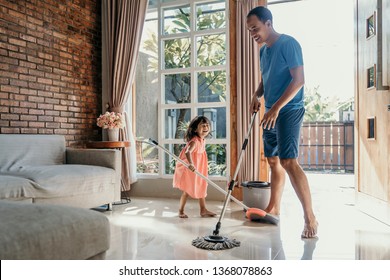 little girl help her daddy to do chores at home