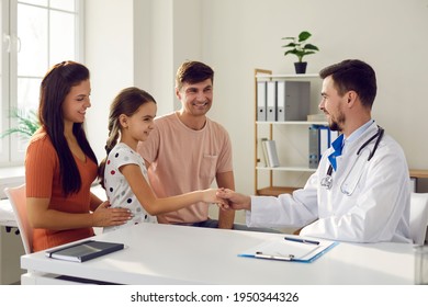 Little girl and her family in consultation with a pediatrician. Child shakes hands and meets the family doctor while sitting in the doctor's office. Concept of pediatrics and health insurance. - Powered by Shutterstock