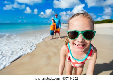 Little girl and her family father and brother enjoying beach vacation in Caribbean - Powered by Shutterstock