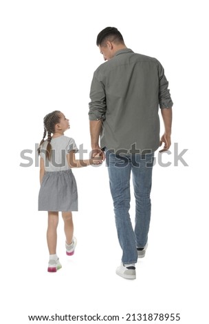Little girl with her father on white background, back view
