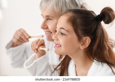 Little girl and her grandma brushing teeth in bathroom, closeup - Powered by Shutterstock