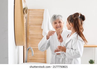 Little girl and her grandma brushing teeth in bathroom - Powered by Shutterstock - Get 15% off with code: PIKWIZARD15