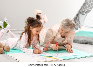 Little Girl And Her Grandma Drawing In Bedroom