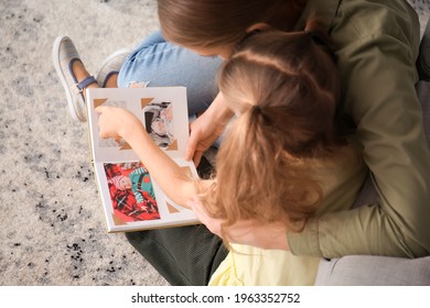 Little Girl And Her Mom With Family Album At Home, Top View