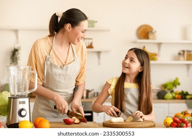 Little girl with her mother cutting fruits for smoothie in kitchen - Powered by Shutterstock