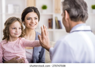 Little Girl With Her Mother At A Doctor On Consultation.