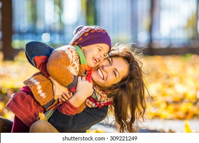 Little girl and her mother playing in the autumn park - Powered by Shutterstock