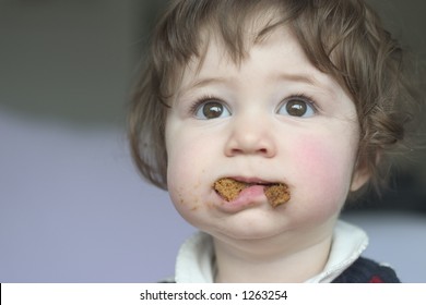 A Little Girl With Her Mouth Full