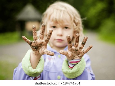 Little Girl With Her Muddy Hands In Green Park