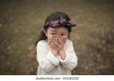 Little girl to hide her face with hands - Powered by Shutterstock