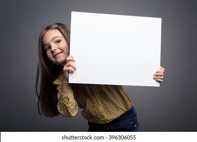 Little girl holding blank white board 