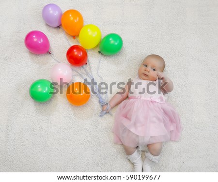 little girl holding a bunch of balloons and a flight shows