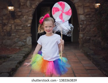 Little Girl Holding A Giant Lollipop