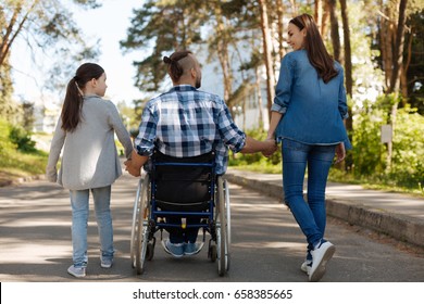 Little girl holding hand of her disabled daddy - Powered by Shutterstock