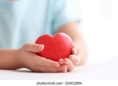 Little girl holding heart in her hands - Powered by Shutterstock