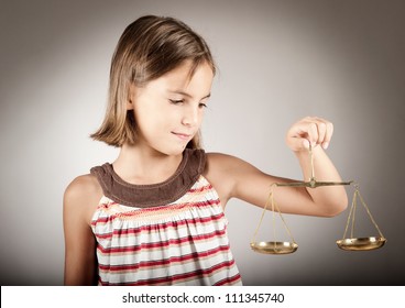 Little Girl Holding Justice Scale