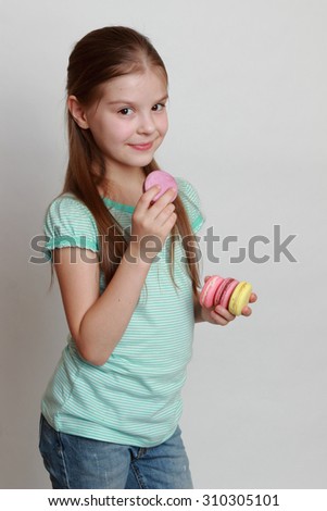 Little girl holding macaroons