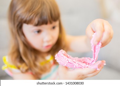 Little Girl Holding Pink Slime