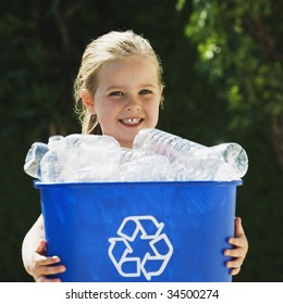 Little Girl Holding Recycling Bin