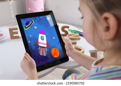 Little girl holding tablet with cute drawing at home. Child art - Powered by Shutterstock