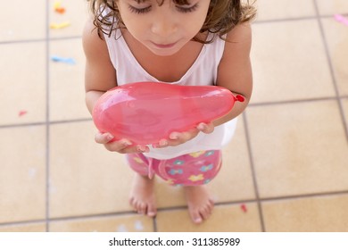 Little Girl Holding A Water Ballon. Concept About End Of The Summer