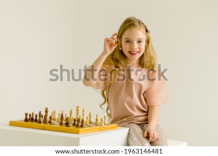 Similar – lifestyle shot of smart kid girl playing checkers at home