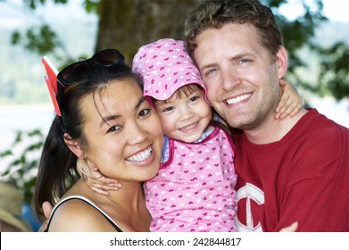 Little girl holds mommy and daddy really tight!