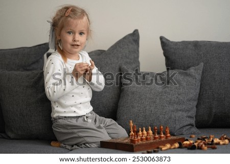 Similar – lifestyle shot of smart kid girl playing checkers at home