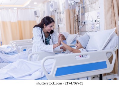 Little girl in hospital bed. Doctor is checking girls condition and showing love and care. - Powered by Shutterstock