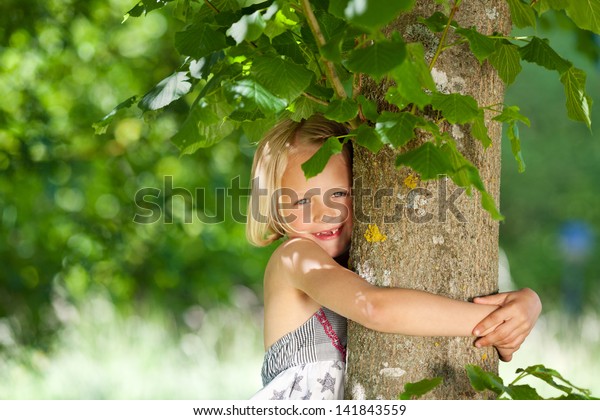 Little Girl Hugging Tree Trunk Stock Photo (Edit Now) 141843559