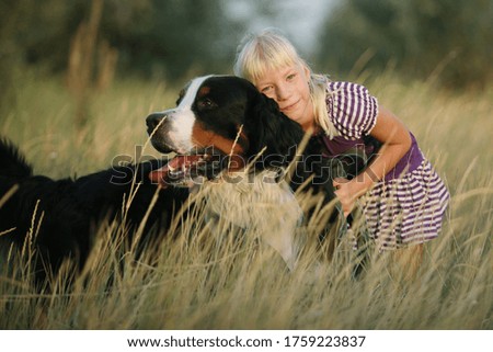 Similar – Image, Stock Photo Blond woman walking her dogs at sunset