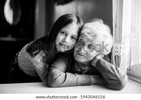 Similar – Grandma cuddles up with her grandson