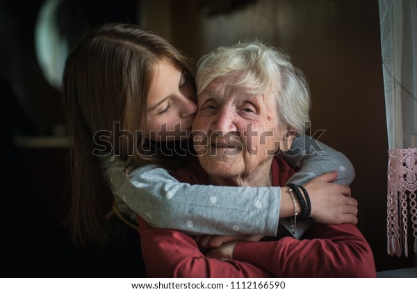 A little girl hugs her
grandmother.
