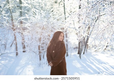 little girl in the icy winter forest. fairy-tale portrait of a child in a brown fur coat in a magical forest. Winter activities and holiday concept. - Powered by Shutterstock - Get 15% off with code: PIKWIZARD15