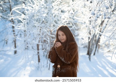 little girl in the icy winter forest. fairy-tale portrait of a child in a brown fur coat in a magical forest. Winter activities and holiday concept. - Powered by Shutterstock - Get 15% off with code: PIKWIZARD15