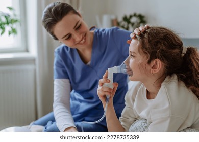 Little girl with inhaler in hospital room, nurse chcecking her.