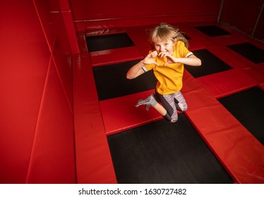 Little Girl Jumping On Trampoline In Fly Park