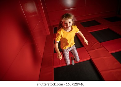Little Girl Jumping On Trampoline In Fly Park