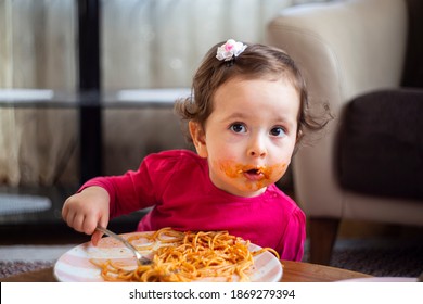 Little Girl Kid Eating Spaghetti Pasta. Spaghetti Pasta Enjoyment With Their Hands. 