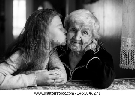 Similar – Young woman talking to elderly woman in wheelchair