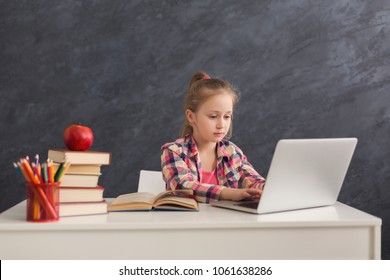 Little Girl With Laptop. Cute Child Doing Homework On Computer. Modern Online Education, Communication And Technology Concept, Copy Space