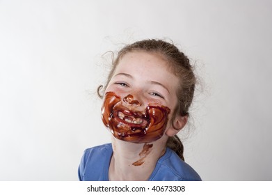 Little Girl Laughing With Chocolate Covered Face