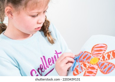 Little Girl Learning How To Sew With Sewing Craft Kit For Kids.