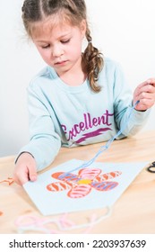 Little Girl Learning How To Sew With Sewing Craft Kit For Kids.