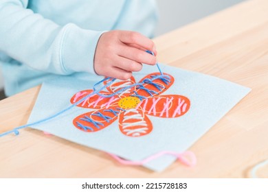 Little Girl Learning How To Sew With Sewing Craft Kit For Kids.