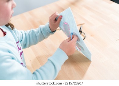 Little Girl Learning How To Sew With Sewing Craft Kit For Kids.