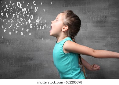 Little girl and letters on grunge background. Speech therapy concept - Shutterstock ID 682205398